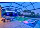 Covered pool area at night offers lounge chairs, integrated spa, and illuminated water features at 8272 Redonda Loop, Bradenton, FL 34202