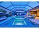 Outdoor pool features integrated spa, illuminated water features, and stylish outdoor furnishings at 8272 Redonda Loop, Bradenton, FL 34202