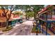 Street view featuring shops, restaurants, and colorful buildings with plenty of trees creating a lively downtown scene at 8272 Redonda Loop, Bradenton, FL 34202