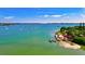 Picturesque waterfront view with boats, docks, an island, and tropical vegetation at 8272 Redonda Loop, Bradenton, FL 34202