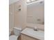 This bathroom features tiled walls, a toilet, and a sink with new hardware and lighting at 860 Virginia St # 304, Dunedin, FL 34698