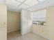 Bedroom featuring a built-in closet, tile floor, and a bright window overlooking greenery at 860 Virginia St # 304, Dunedin, FL 34698