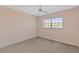 This bedroom features neutral carpet, light pink painted walls, and a window at 860 Virginia St # 304, Dunedin, FL 34698