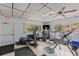 Well-equipped fitness center with various exercise machines and ample natural light from large windows at 860 Virginia St # 304, Dunedin, FL 34698