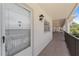 Condo entryway featuring a secure door, hallway, and decorative lighting at 860 Virginia St # 304, Dunedin, FL 34698