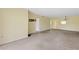A spacious living area with neutral carpet, paint, and fixtures in a well lit room at 860 Virginia St # 304, Dunedin, FL 34698