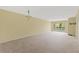 Spacious living room with neutral carpet and sliding doors to a balcony at 860 Virginia St # 304, Dunedin, FL 34698