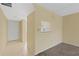 A bright open-plan living room area with neutral paint, carpet, and a passthrough to the kitchen at 860 Virginia St # 304, Dunedin, FL 34698