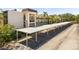 Exterior shot of covered parking with building and landscape in the background at 860 Virginia St # 304, Dunedin, FL 34698