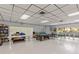 Large recreation room with a pool table, seating, and game shelves perfect for entertaining and relaxation at 860 Virginia St # 304, Dunedin, FL 34698