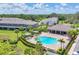 Aerial view showcases a community pool, lounge area, and lush landscaping within a well-maintained neighborhood at 8628 Milestone Dr, Sarasota, FL 34238