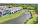 Aerial view of townhomes overlooking a serene pond with a fountain and lush green landscaping at 8628 Milestone Dr, Sarasota, FL 34238