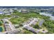 An aerial view of the community highlights the layout, green spaces, lake, and nearby amenities at 8628 Milestone Dr, Sarasota, FL 34238