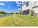 Beautiful backyard view of townhomes, a serene pond with fountain, and lush green grass at 8628 Milestone Dr, Sarasota, FL 34238