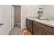 Bathroom featuring double sinks, wood cabinets and shower at 8628 Milestone Dr, Sarasota, FL 34238