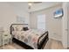 Bright bedroom with ceiling fan, TV, window with blinds, and a comfortable bed with colorful bedding at 8628 Milestone Dr, Sarasota, FL 34238