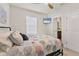 Comfortable bedroom with ceiling fan, TV, window with blinds, and a comfortable bed with colorful bedding at 8628 Milestone Dr, Sarasota, FL 34238