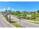 Entrance to Promenade East, with manicured landscaping, palm trees, and clear signage at 8628 Milestone Dr, Sarasota, FL 34238