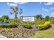Elegant Promenade East community sign amidst lush landscaping and flowering plants at 8628 Milestone Dr, Sarasota, FL 34238