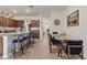 Open concept kitchen and dining area with seating for six and a large island with barstools at 8628 Milestone Dr, Sarasota, FL 34238