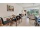 Open concept floor plan with dining area and living room with sliders to outside at 8628 Milestone Dr, Sarasota, FL 34238