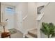 Welcoming foyer with stairs, tiled floors, and a decorative plant, creating a warm entry at 8628 Milestone Dr, Sarasota, FL 34238