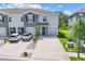 Two-story townhome features a gray facade, manicured lawn and driveway for two cars at 8628 Milestone Dr, Sarasota, FL 34238