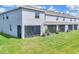 Exterior view of a modern townhome featuring a screened lanai and well-maintained lawn at 8628 Milestone Dr, Sarasota, FL 34238
