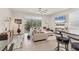 Open concept living room featuring a large sofa, TV, and an abundance of natural light at 8628 Milestone Dr, Sarasota, FL 34238
