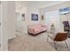 Cozy sitting room with pink couch, modern chair, and natural light at 8628 Milestone Dr, Sarasota, FL 34238