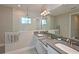Modern bathroom features double sink vanity and a large shower with glass door at 8916 Isabella Cir, Parrish, FL 34219