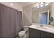 Bathroom featuring modern vanity with drawers, white countertops, and shower with gray curtain at 8916 Isabella Cir, Parrish, FL 34219