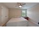 Bedroom features neutral walls, ceiling fan, and window with plantation shutters at 8916 Isabella Cir, Parrish, FL 34219