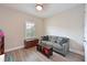 Neutral bedroom with hardwood floors, a gray couch and wood accents at 8916 Isabella Cir, Parrish, FL 34219