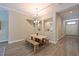 Bright dining room with wood floors and a view into the entry hall at 8916 Isabella Cir, Parrish, FL 34219