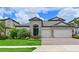 Beautiful single Gathering home features brick driveway, lush landscaping, and an attached two car garage at 8916 Isabella Cir, Parrish, FL 34219