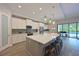 Gourmet kitchen with a center island, stainless steel appliances, lots of storage, and views of the backyard pool at 8916 Isabella Cir, Parrish, FL 34219