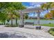 Lakeside retreat with a charming swing invites relaxation amidst picturesque scenery, offering a tranquil escape at 8916 Isabella Cir, Parrish, FL 34219