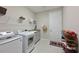 Bright laundry room with modern appliances and storage shelves at 8916 Isabella Cir, Parrish, FL 34219