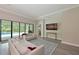 Bright living room with hardwood floors, crown moulding, sliding doors, and comfortable seating at 8916 Isabella Cir, Parrish, FL 34219