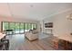 Open-concept living room has hardwood floors, neutral walls, crown moulding, and sliding doors at 8916 Isabella Cir, Parrish, FL 34219