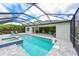 Screened pool and spa with lounge area, privacy, and beautiful blue skies at 8916 Isabella Cir, Parrish, FL 34219