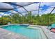 Relaxing screened-in pool with an integrated hot tub offers a private backyard oasis at 8916 Isabella Cir, Parrish, FL 34219