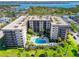 Scenic aerial shot showcasing the building's architecture, pool, and the surrounding waterfront at 1001 Benjamin Franklin Dr # 106, Sarasota, FL 34236