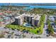 Aerial view of the condo community, highlighting the pool, manicured grounds, and waterfront location at 1001 Benjamin Franklin Dr # 106, Sarasota, FL 34236