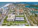 Aerial view featuring a condo complex near the beach, with parking, landscaping, and neighborhood details at 1001 Benjamin Franklin Dr # 106, Sarasota, FL 34236