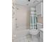 Bathroom featuring a toilet, vanity, shower/tub combination with white tiles and a shower curtain at 1001 Benjamin Franklin Dr # 106, Sarasota, FL 34236