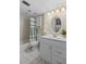 Bathroom featuring a toilet, vanity, mirror, and shower/tub combination with a shower curtain at 1001 Benjamin Franklin Dr # 106, Sarasota, FL 34236