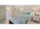 This bedroom features a comfortable bed, white furniture, and an ensuite bathroom at 1001 Benjamin Franklin Dr # 106, Sarasota, FL 34236