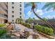 Exterior of the property, showcasing the picnic seating, grills, and patio area at 1001 Benjamin Franklin Dr # 106, Sarasota, FL 34236
